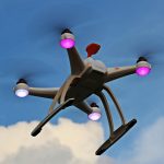 A quadcopter drone with propellers and lights flying high against a blue sky with clouds.